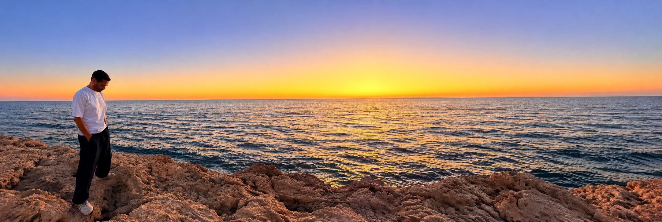 Dr Simon Lewis beside the sea at sunset